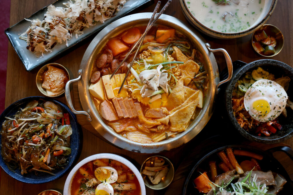 Army Stew, center, surrounded by a variety of dishes at Seoul to Tokyo restaurant in Santa Rosa Monday, May 4, 2026. (Beth Schlanker / The Press Democrat)
