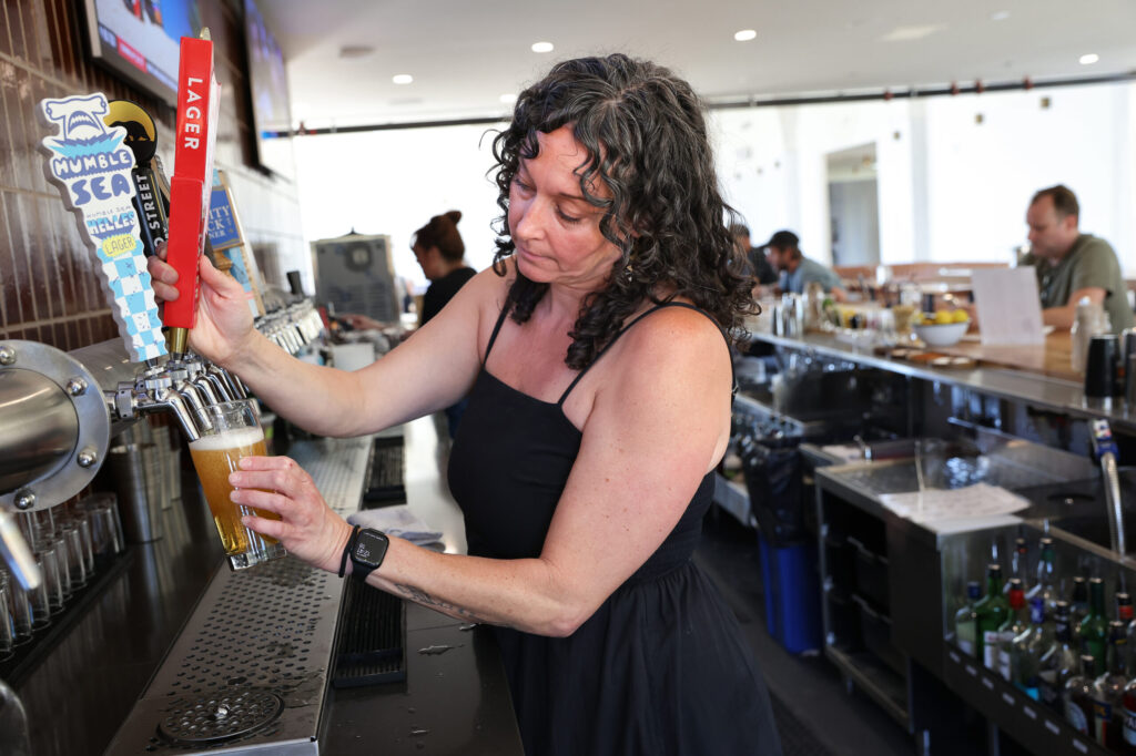 Manager Melissa Schwartz pours a beer at The Junction in Santa Rosa on Monday, May 18, 2026. (Christopher Chung/The Press Democrat)