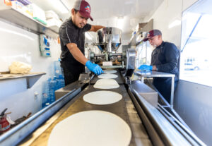 Gregorio Chavez, left, makes sure the size is right while Ramiro Garcia stacks fresh corn tortillas Friday, Jan. 16, 2026, inside the Tortilleria La Loteria fresh tortilla factory food truck on Stony Point Road in Santa Rosa. (John Burgess / The Press Democrat)
