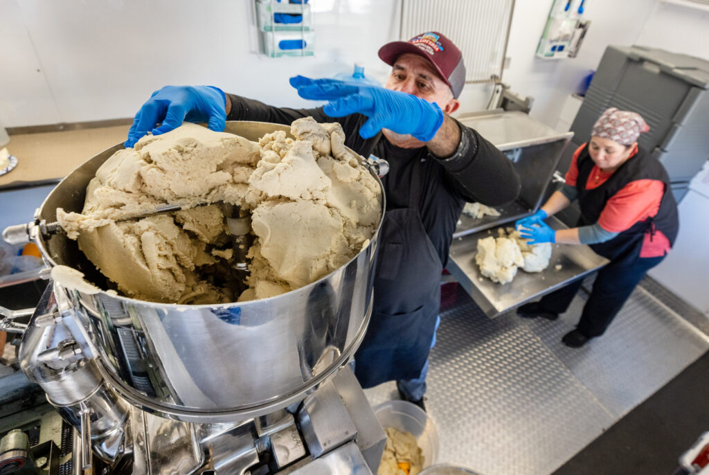 Ramiro Garcia fills the feeder for the fresh tortilla making machine Friday, Jan. 16, 2026, while his sister Lucrecia unloads the mixer inside the Tortilleria La Loteria food truck on Stony Point Road in Santa Rosa. (John Burgess / The Press Democrat)