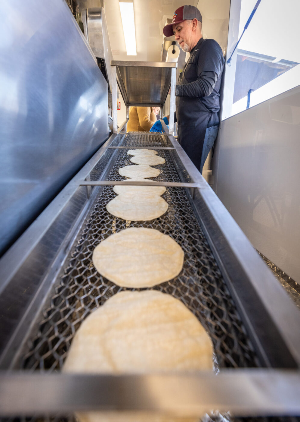 Ramiro Garcia stacks fresh corn tortillas Friday, Jan. 16, 2026, inside the Tortilleria La Loteria fresh tortilla factory food truck on Stony Point Road in Santa Rosa. (John Burgess / The Press Democrat)
