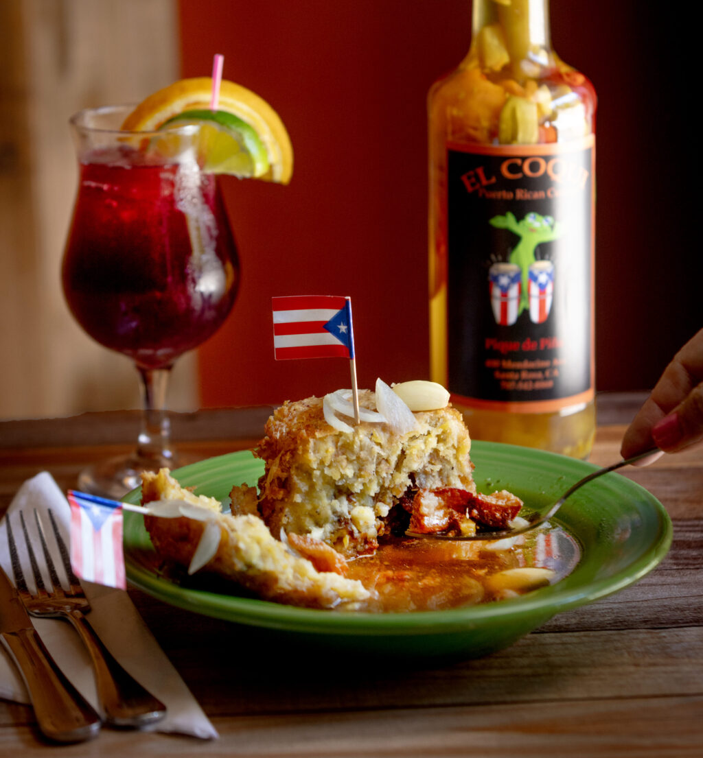 Mofongo, a tower of fried green plantains crushed with fresh garlic and olive oil with crispy pork belly and a Sangria from El Coqui Puerto Rican Cuisine Friday, May 8, 2026 in downtown Santa Rosa. (John Burgess/The Press Democrat)