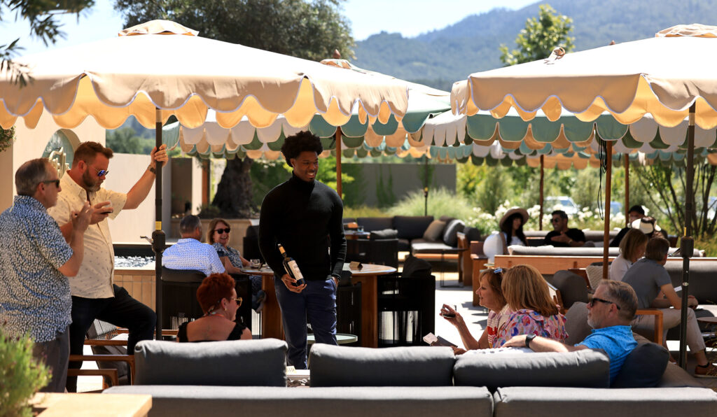 Ta’Rod Kenney discusses a vintage to guests at the outdoor Wren Bar patio, located at Bella Union Winery, Saturday, May 9, 2026, in Rutherford. (Kent Porter / The Press Democrat)
