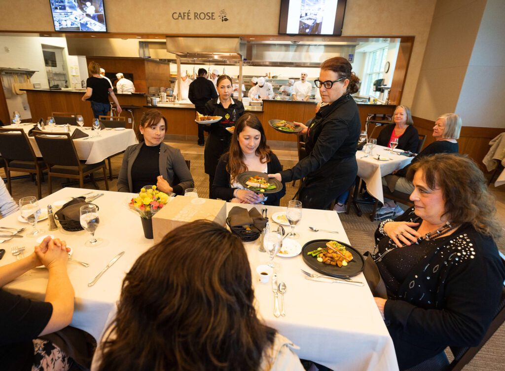 Students in the Santa Rosa Junior College culinary program serve lunch to college employees celebrating a birthday and the reopening of Café Rose on campus Tuesday, April 20, 2023. (John Burgess / The Press Democrat)