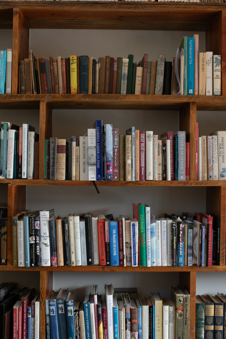 The living room bookcase is filled with cookbooks, many signed by luminaries in the culinary world. (Eileen Roche)