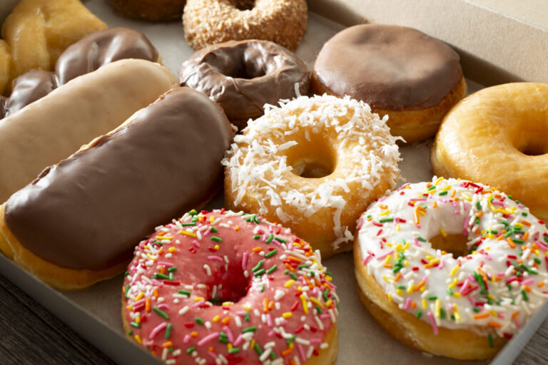 A view of a dozen donuts in a box. (Photography By Tonelson / Getty Images)
