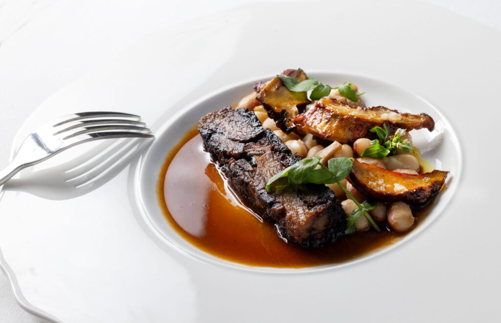 Crane Ranch Lamb with white beans, locally foraged lobster mushrooms and lamb jus from the Bohemian Bistro Friday, June 12, 2026 in Occidental. (John Burgess/The Press Democrat)