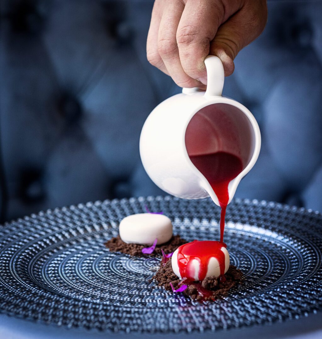 Fermented raspberry sauce tops the Raspberry Mousse with chocolate crumble before a few drops of mint oil from the Bohemian Bistro Friday, June 12, 2026 in Occidental. (John Burgess/The Press Democrat)