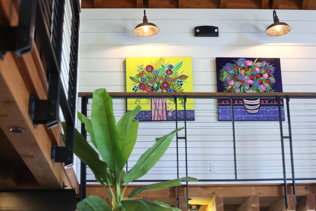 Paintings by Heidi Peterson Barrett hang on display for sale at La Sirena tasting room in Calistoga Wednesday, May 13, 2026. (Beth Schlanker / The Press Democrat)