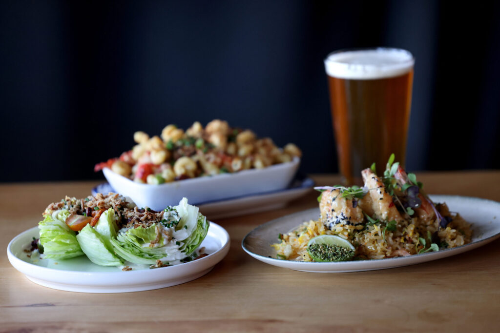 The Wedge salad, left, Lobster Mac n’ Cheese, rear, and Yum Yum Prawns at Seared in Petaluma Thursday, June 18, 2026. (Beth Schlanker / The Press Democrat)