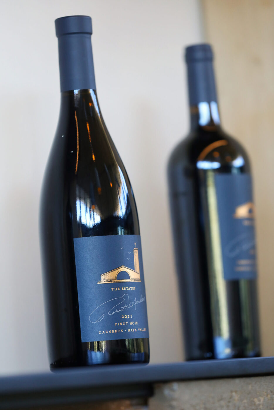 Bottles of Robert Mondavi Winery Pino Noir wine in the Reception Room of the winery in Oakville on Wednesday, June 24, 2026. (Christopher Chung/The Press Democrat)