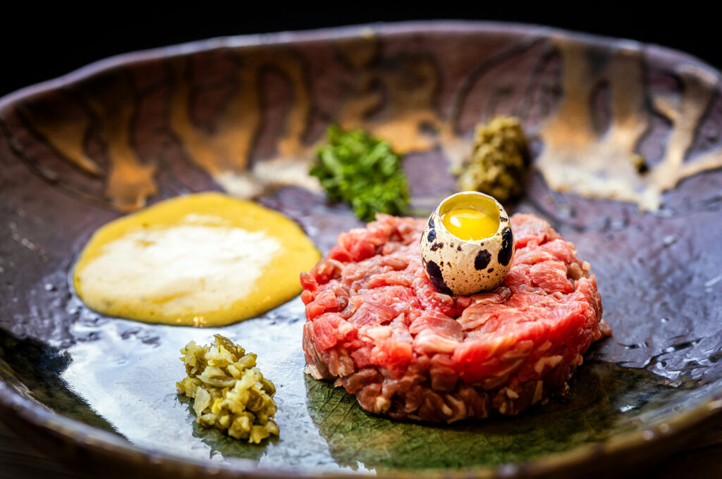 Traditional tableside steak tartare with hand-cut flank steak, quail egg, cornichons, capers, olive oil, Dijon mustard and pommes gaufrette from Brigitte Bistro in Petaluma. (John Burgess / The Press Democrat)