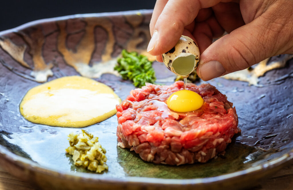 Traditional tableside steak tartare with hand-cut flank steak, quail egg, cornichons, capers, olive oil, Dijon mustard and pommes gaufrette from Brigitte Bistro in Petaluma. (John Burgess / The Press Democrat)