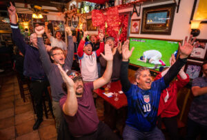 World Cup fans celebrate at the final whistle at the USA beat Iran, 1-0, at AusielloÕs 5th Street Bar & Grill in Santa Rosa Tuesday, November 29, 2022. The US advances to the knock out round where they play the Netherlands next Saturday. (John Burgess/Press Democrat)