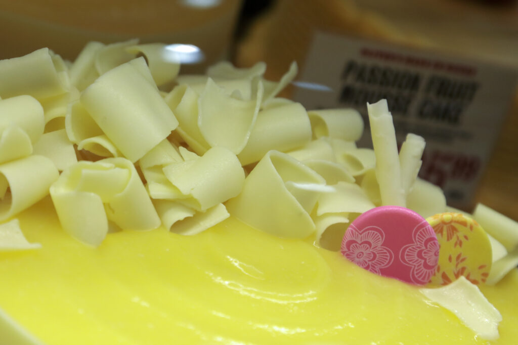 Oliver's Market's lemon mousse cake is wrapped in white chocolate and garnished with white chocolate curls atop rich, tangy lemon curd. (Sonoma County Tourism)