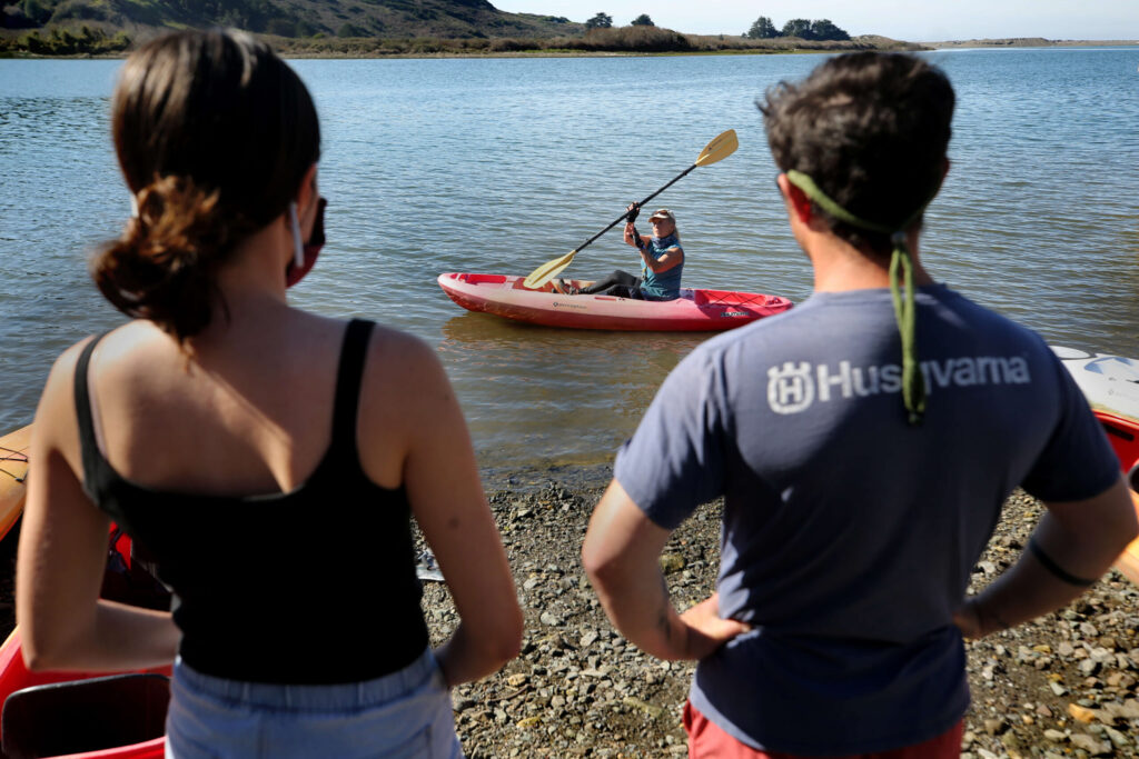 Suki Waters, owner of WaterTreks EcoTours, leads a safety demonstration for Sabrina Paredes, left, and Cody Darling in Jenner, Calif., on Sunday, February 13, 2022.(Beth Schlanker/The Press Democrat)