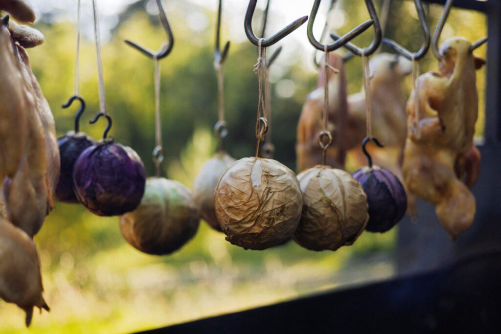 Chef Lee Desrosiers slow-roasts cabbage over hot coals alongside whole chickens. (Conor Hagen)