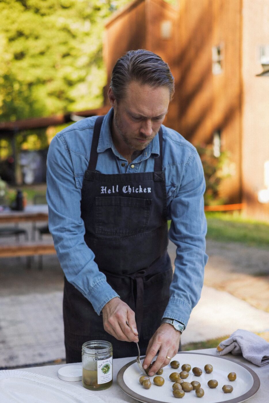 Chef Lee Desrosiers prepares a simple appetizer with olives and chiles. (Conor Hagen)