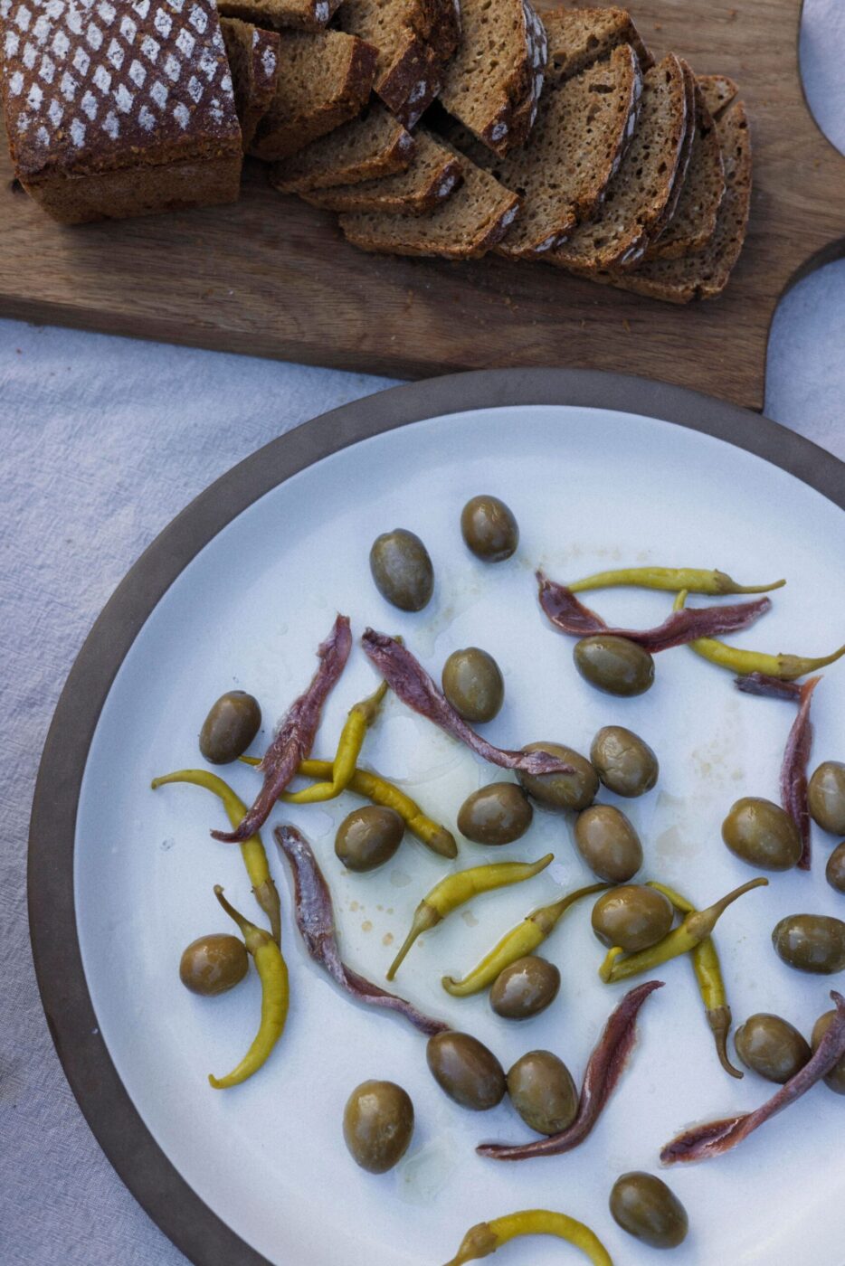 A simple appetizer like olives with chiles is an ideal complement to chef Lee Desrosiers' signature "Hell Chicken" and makes for easy outdoor summer entertaining. (Conor Hagen)