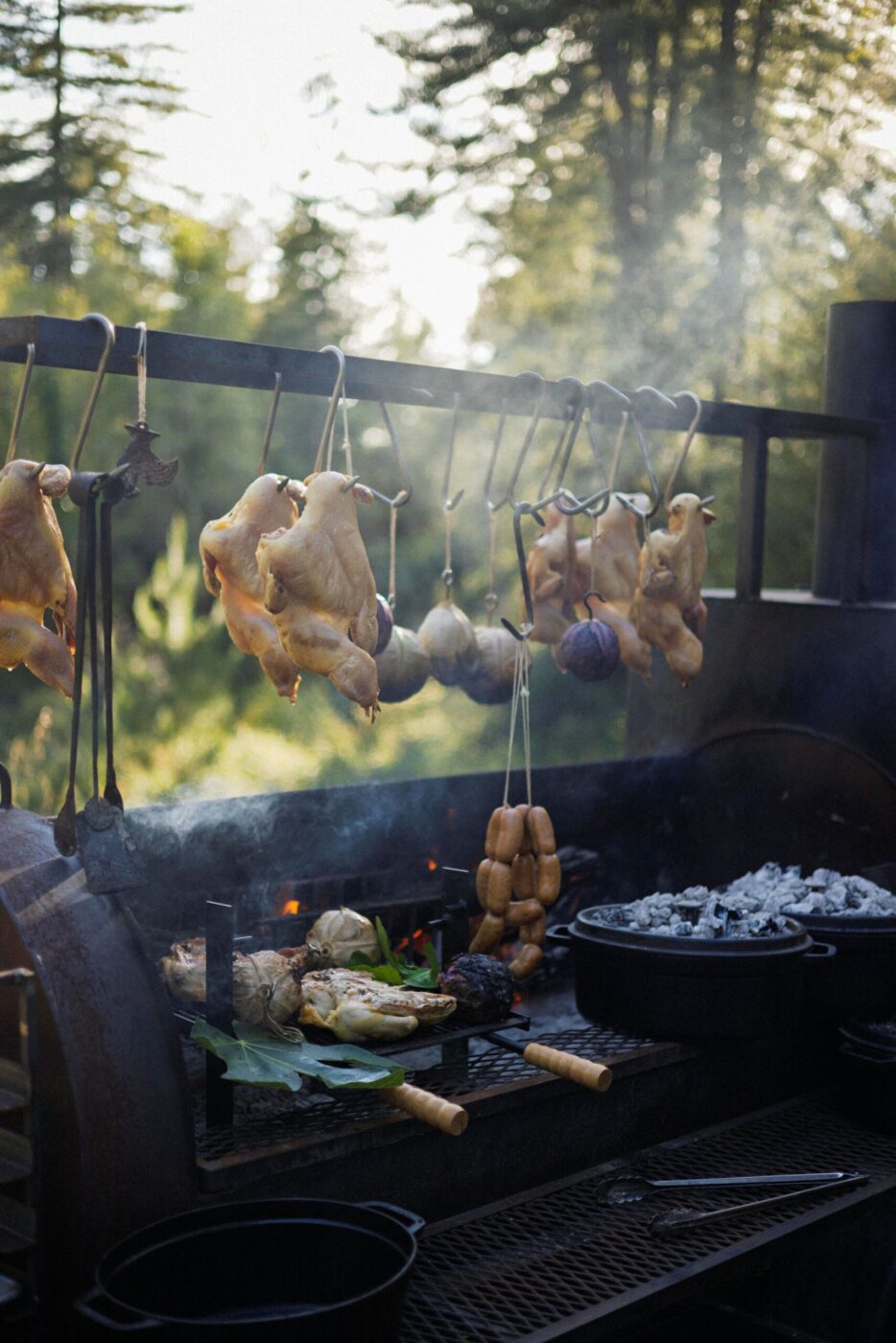 Chef Lee Desrosiers slow-roasts his signature "Hell Chicken" over coals in a converted pig smoker. (Conor Hagen)