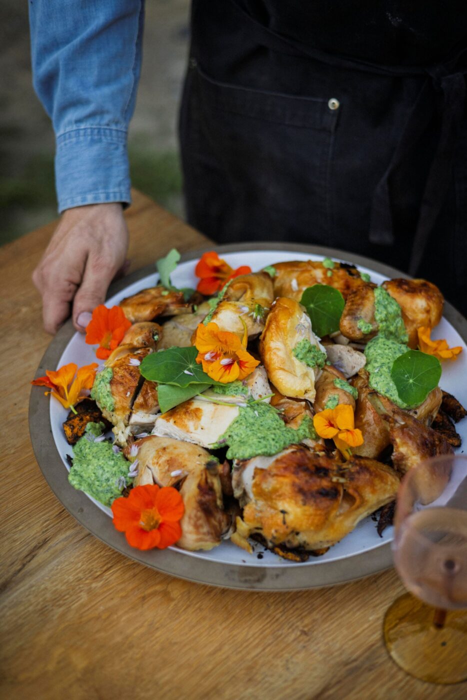 The signature dish at Lee Desrosiers' outdoor dinners is "Hell Chicken," cooked over an open fire, which Desrosiers says invites guests into the cooking process. (Conor Hagen)