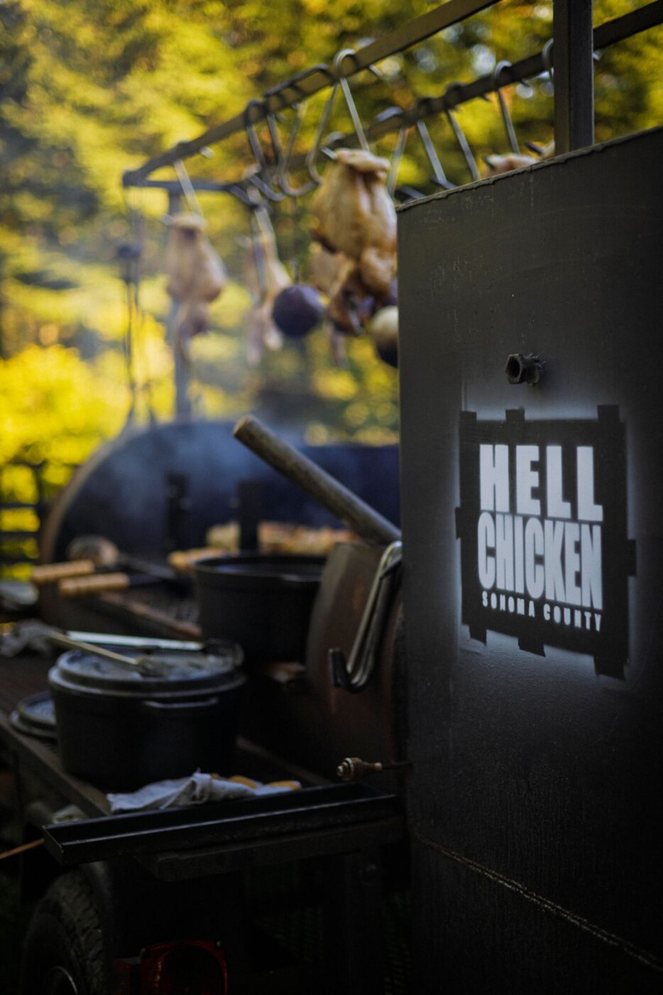 Chef Lee Desrosiers slow-roasts his signature "Hell Chicken" over coals in a converted pig smoker. (Conor Hagen)