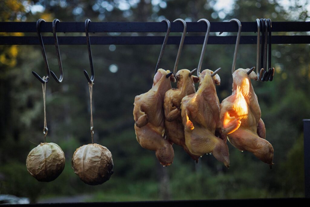 Chef Lee Desrosiers slow-roasts whole chickens and cabbage over hot coals. (Conor Hagen)