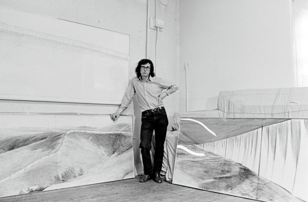 Christo in his studio with preparatory drawings for Running Fence in New York City, 1974. (Wolfgang Volz / courtesy Christo and Jeanne-Claude Foundation)
