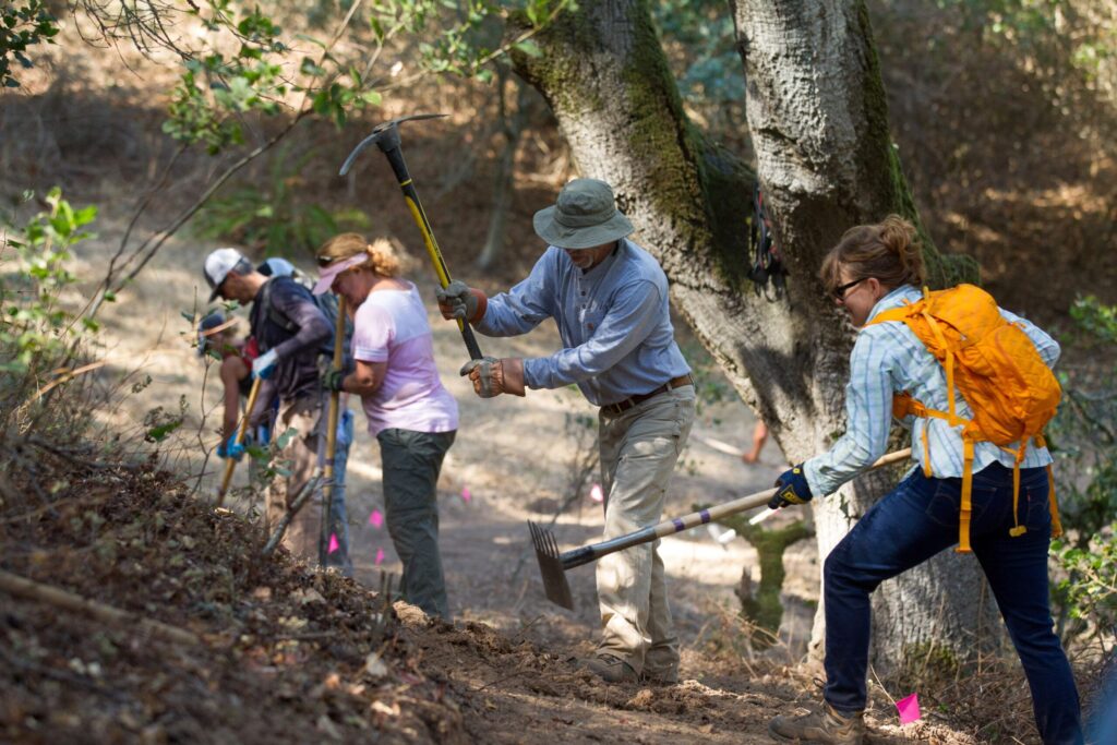 Volunteers for Sonoma County Trails Council clear away a new part of Fillaree Trail at Helen Putnam Regional Park, in Petaluma, on Saturday, September 30, 2017. (Darryl Bush / For The Press Democrat)