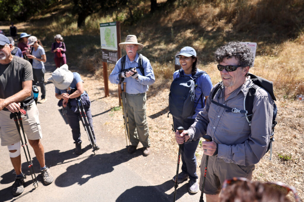 Zoli Somogyi, right, talks to a group with “Go Wild Hikers” after a hike at Shiloh Ranch Regional Park in Windsor Sunday, May 31, 2026. (Beth Schlanker / The Press Democrat)