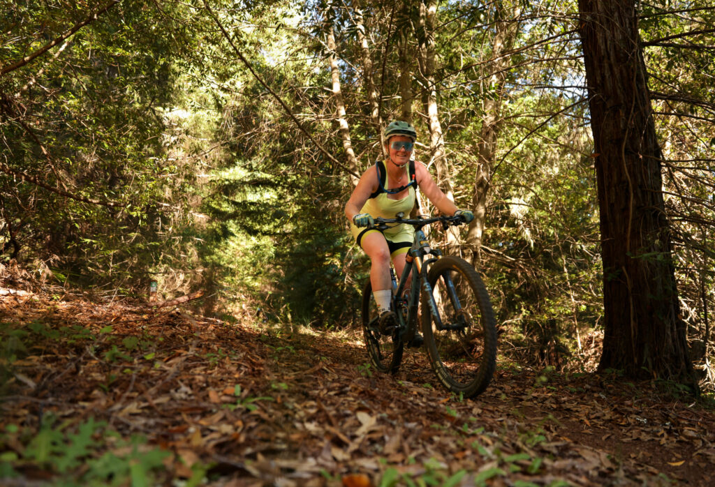 Katy Bayless rides down the Office trail in the Monte Rio Redwoods Regional Park & Open Space Preserve near Occidental on Thursday, June 11, 2026. (Christopher Chung/The Press Democrat)