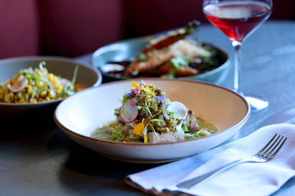 Iberia pork steak with tomatillo crudo, Anaheim relish, and hominy at Dead Letter restaurant in Sonoma Wednesday, July 15, 2026. (Beth Schlanker / The Press Democrat)