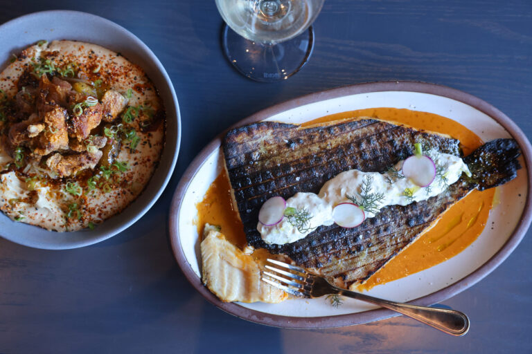 Chicken Karaage, left, on a bed of tahini hummus and the butterflield trout, right, in a red curry and topped with cucumber yogurt at Dead Letter restaurant in Sonoma Wednesday, July 15, 2026. (Beth Schlanker / The Press Democrat)