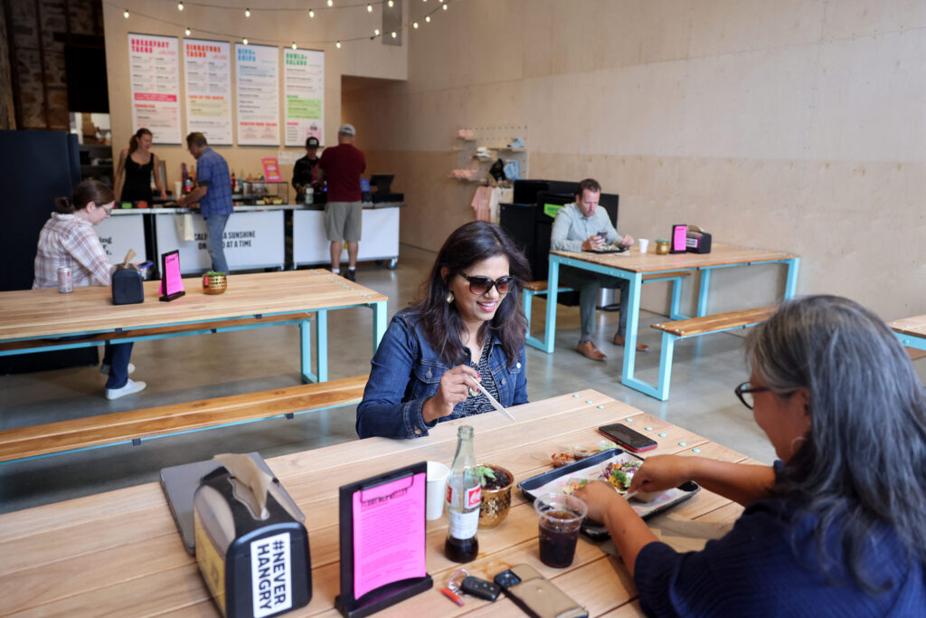 Customers Seena Shanker, center, and Elaine Lund, right, eat lunch at Ray Ray’s Tacos in St. Helena Tuesday, Sept. 9, 2025. (Beth Schlanker / The Press Democrat)