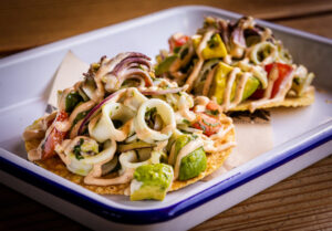 La Sirena Tostada with poached calamari, tomato, avocado, red onion, cilantro, lime and chipotle aioli from Handline Thursday, July 9, 2026 in Sebastopol. (John Burgess/The Press Democrat)