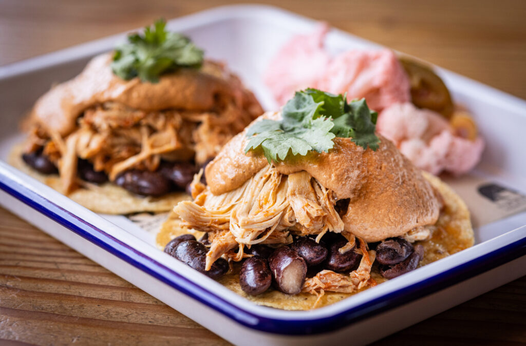The Pollo Correcto Tostada with organic chicken, fancy beans, CA mole, cilantro and pickled vegetable salad from Handline Thursday, July 9, 2026 in Sebastopol. (John Burgess/The Press Democrat)