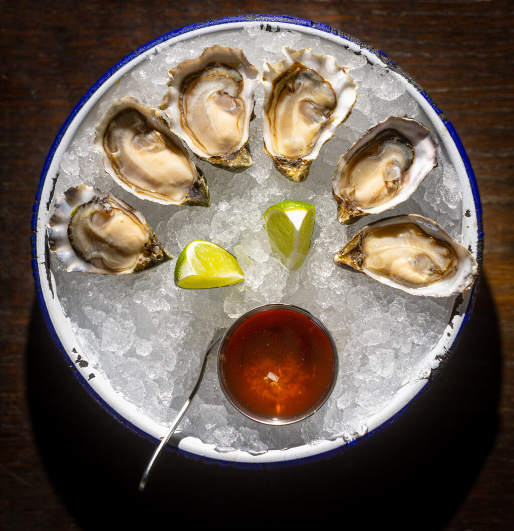 Simple fresh oysters, shown here, along with grilled oysters piled with unique ingredients from Handline Thursday, July 9, 2026 in Sebastopol. (John Burgess/The Press Democrat)