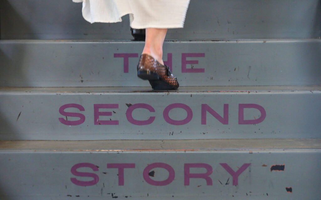 A guest makes their way up the stairs to watch the band performance at Little Saint in Healdsburg on Thursday, July 9, 2026. (Christopher Chung/The Press Democrat)