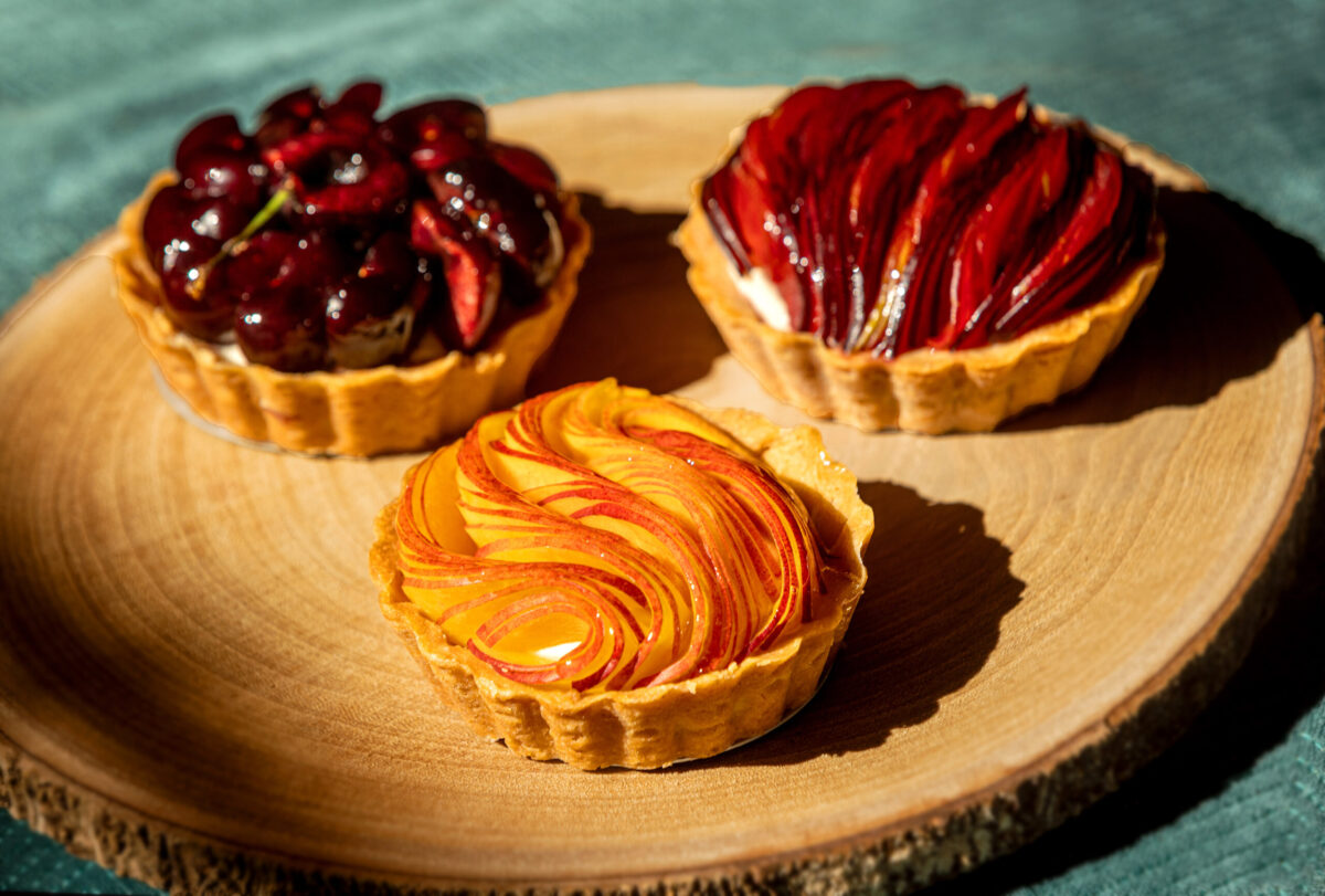 A Trio of Seasonal Fruit Tarts, cherry, nectarine and peach, with pâte sucrée, almond frangipane and vanilla bean diplomat cream from Little Saint in Healdsburg. (John Burgess/The Press Democrat)