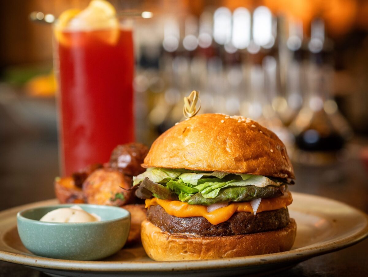 Little Saint Burger with Hearth Oven Potatoes & Rosemary garlic aioli with housemade seitan & beet patty, Little Saint special sauce, gem lettuce, melty cheese, farm tsukemono, sweet onion on a sesame seed potato brioche bun from Little Saint in Healdsburg. (John Burgess/The Press Democrat)