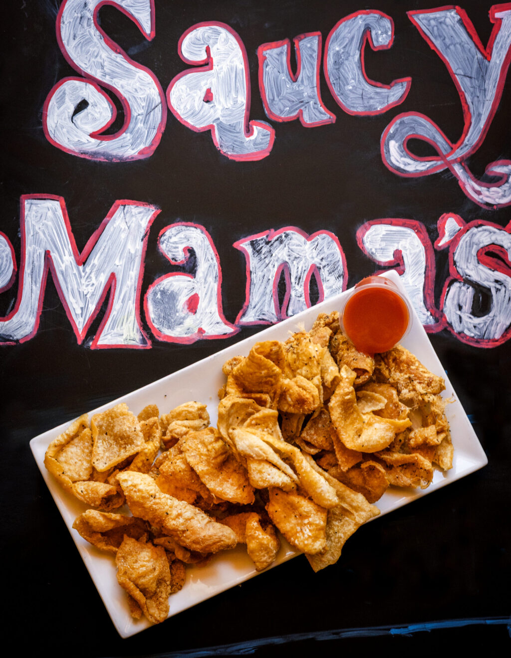 Cracklin' Chicken seasoned, deep fried to a crisp and served with a side of hot sauce from Saucy Mama’s Jook Joint Friday, July 18, 2026 in Guerneville. (John Burgess/The Press Democrat)