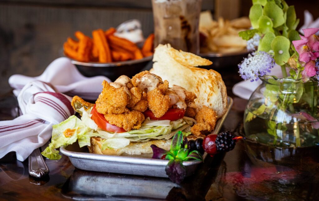 Oyster po'boy dredged and deep fried, served on a Bolillos bun with lettuce, tomato and remoulade sauce from Saucy Mama’s Jook Joint Friday, July 18, 2026 in Guerneville. (John Burgess/The Press Democrat)