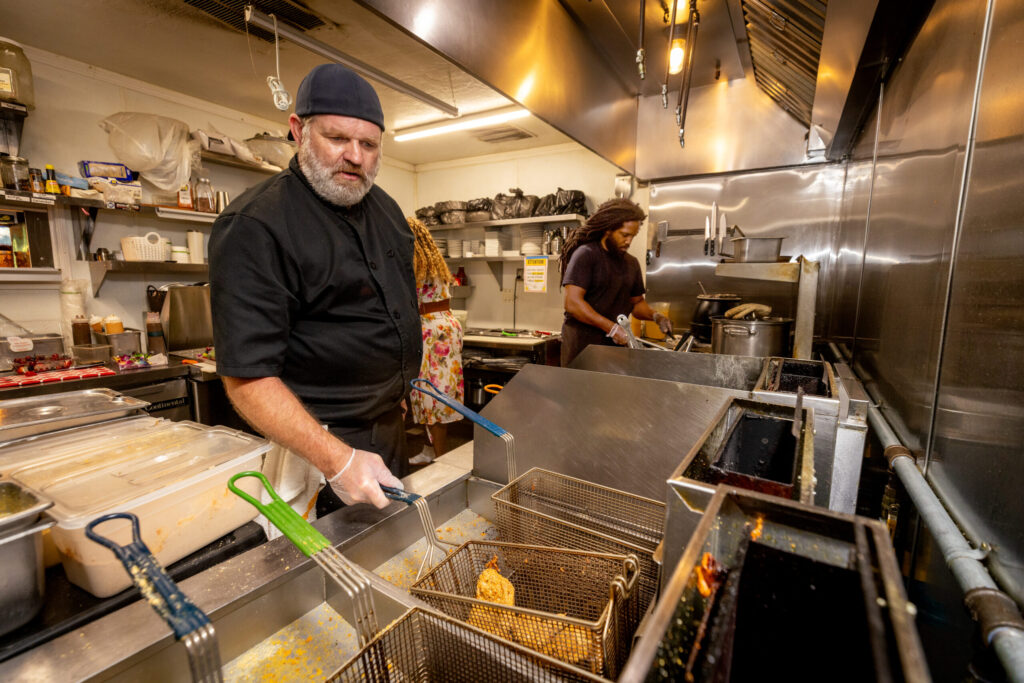 Dylan Bartlett runs the deep fryer the kitchen at Saucy Mama’s Jook Joint Friday, July 18, 2026 in Guerneville. (John Burgess/The Press Democrat)