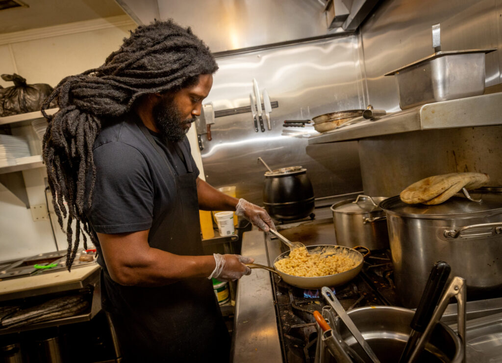 Joshua Curtiss makes an order of Mac & Cheese in the kitchen at Saucy Mama’s Jook Joint Friday, July 18, 2026 in Guerneville. (John Burgess/The Press Democrat)