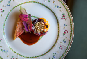 Duck au Pruneaux, featuring black truffle mousseline, lambs quarters, and ume shu, served at Troubadour Bread & Bistro in Healdsburg on Thursday, July 2, 2026. (Christopher Chung/The Press Democrat)