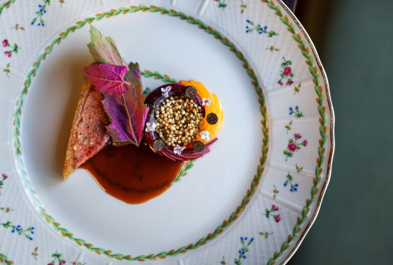 Duck au Pruneaux, featuring black truffle mousseline, lambs quarters, and ume shu, served at Troubadour Bread & Bistro in Healdsburg on Thursday, July 2, 2026. (Christopher Chung/The Press Democrat)