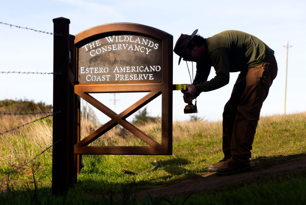 Ranger Quinn Whisman works on the new gate at the trailhead of the recently opened Estero Americano Coastal Preserve Friday Jan 30, 2026 in Bodega Bay. (John Burgess / The Press Democrat)