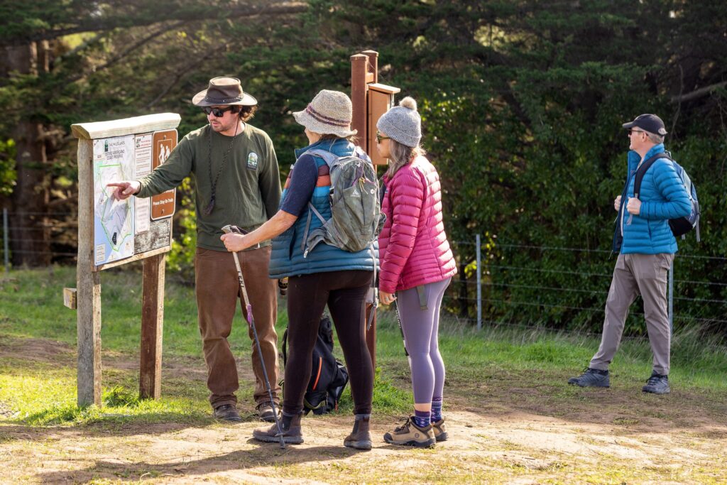 Ranger Quinn Whisman, left, shows hikers the map at the trailhead of the recently opened Estero Americano Coastal Preserve on Friday, Jan. 30, 2026 in Bodega Bay. (John Burgess / The Press Democrat)