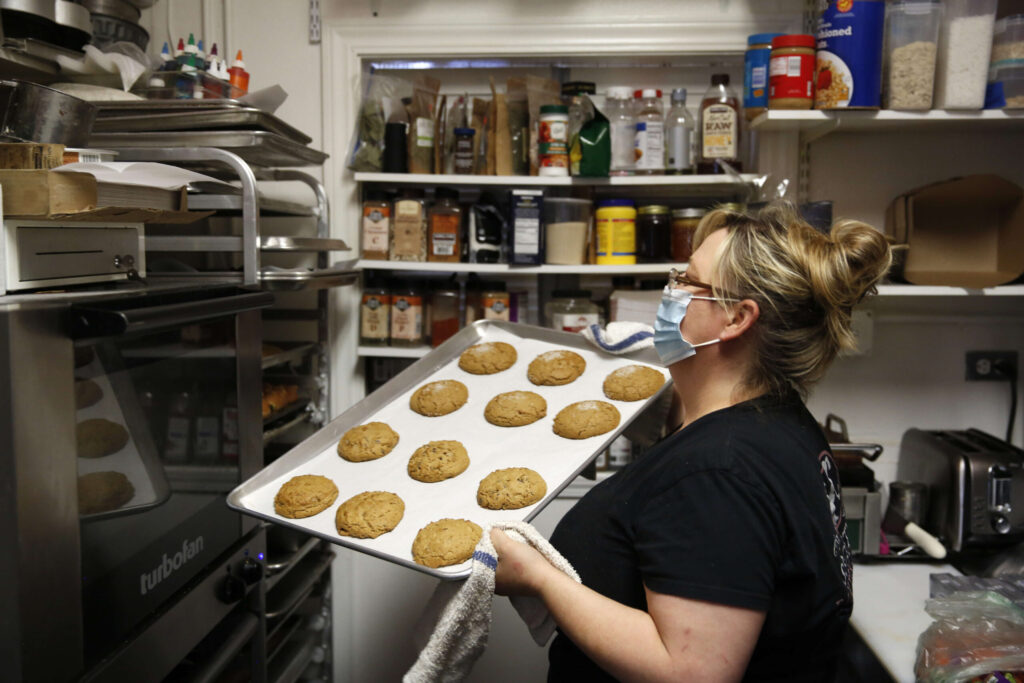 Jeannette Barbieri takes cookies out of the oven at Society Bakery and Cafe in Sebastopol on Wednesday, September 22, 2021. (Beth Schlanker/The Press Democrat)