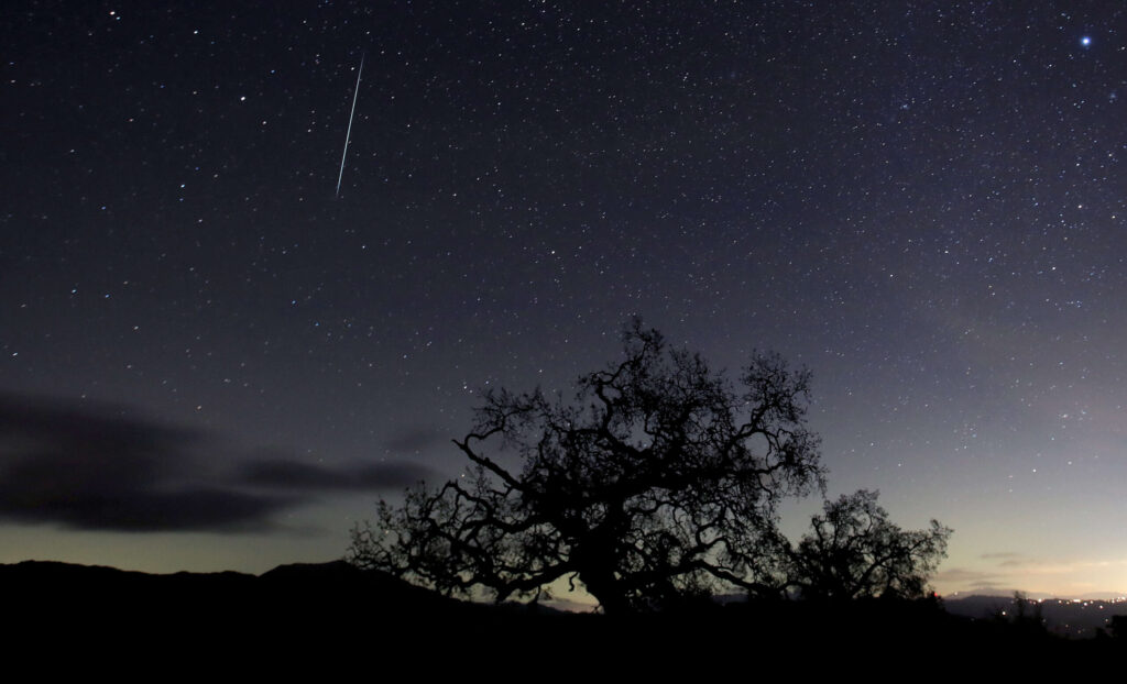 A meteor leaves a trail above the Geysers area of Sonoma County, Monday, Dec. 14, 2020. The earth passes through a dust trail from the asteroid 3200 Phaethon near the bright constellation Gemini, the Twins. The first sightings of the annual December meteor shower occurred in the 1800's. Although the peak of the meteor shower was late Sunday, early Monday, meteors will be visible through the late part of December. (Kent Porter / The Press Democrat) 2020